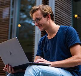 UB online student with a laptop